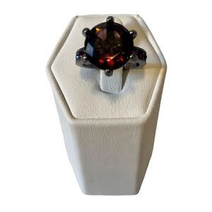 Beautiful Purple Stone Solitaire w/ 3 smaller stones on each side.